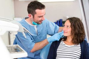 Dentist applying dental implant restorations