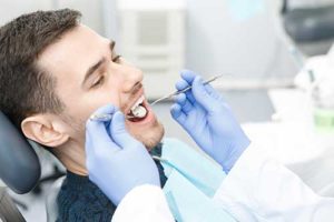 Man getting an exam in preparation for same day dental crowns